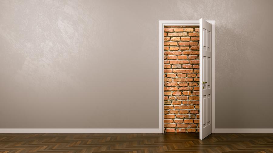 An open door on an interior wall where the opening is closed off by bricks.